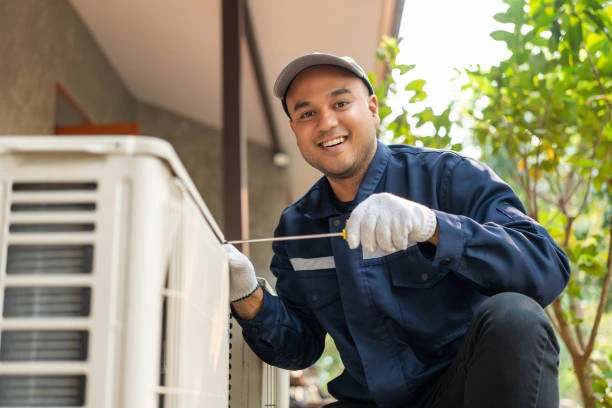 Illustrative technician alongside a residential outdoor air conditioning unit